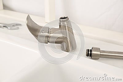 Disassembled water tap .near sink on countertop Stock Photo