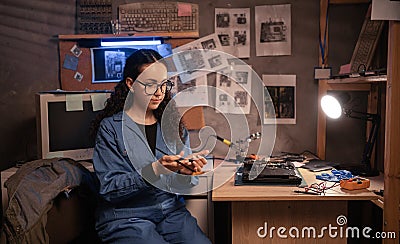 Disassembling a notebook and cleaning its cooling system. Clean dust and dirt on computer fan. Computer repairman Stock Photo