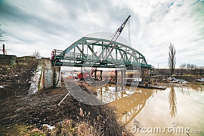 Disassembly and cutting of the old steel railway bridge and rusty rails Stock Photo