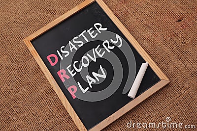 Disaster Recovery Plan, text words typography written on chalkboard against wooden background, life and business motivational Stock Photo