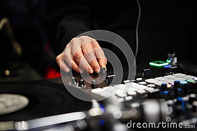 Hip hop dj mixing musical tracks with sound mixer and vinyl turntables Stock Photo