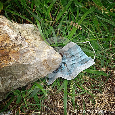 Discarded face masks are becoming an environmentally disastrous by-product of Covid 19 Stock Photo