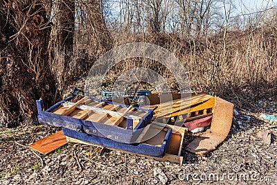Discarded furniture in nature. Garbage Dumped in Beautiful Nature Stock Photo