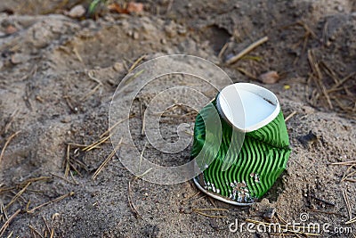 Discarded Paper coffee cup on ground. Disposable coffee cup on sand. The problem of environmental pollution. Pile of abandoned Stock Photo