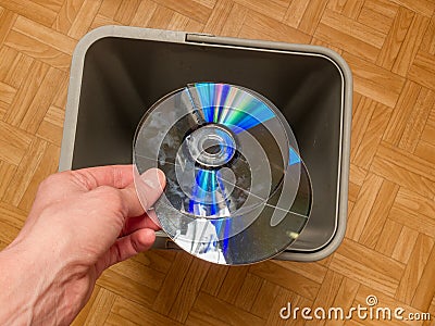 Discarding a computer laser CD, the concept of obsolescence of computer components, the evolution of computer parts Stock Photo