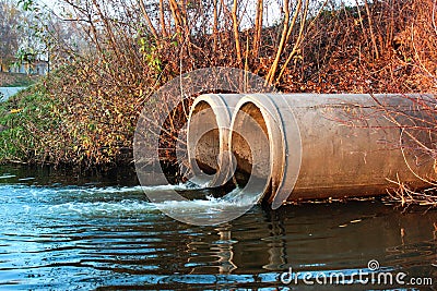 Discharge of sewage into a river Stock Photo