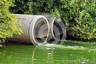 Discharge of sewage into a river Stock Photo