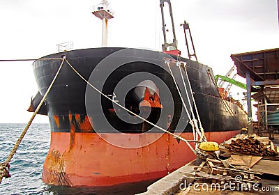 Discharging of cargo scrap metal from cargo ship in the port of Iskenderun, Turkey. A close-up view of cargo residues on the deck Stock Photo