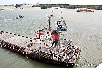 Discharging the vessel in the port of Saigon, Vietnam, the Mekong River. Views of berths, river banks and ships,tugs. Stock Photo