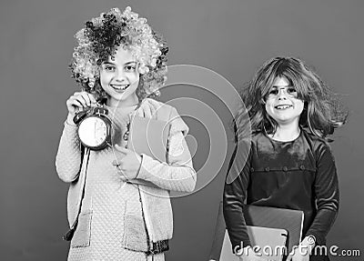 Discipline and time concept. Circus school education. Time to have fun. Kids colorful curly wig clown style hold alarm Stock Photo
