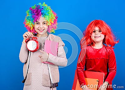 Discipline and time concept. Circus school education. Time to have fun. Kids colorful curly wig clown style hold alarm Stock Photo