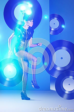 Disco african woman dancing with vinyl records and neon light Stock Photo