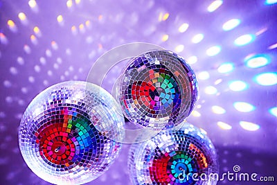 Disco balls with mirror reflections and lights at a night party in a bar or club Stock Photo
