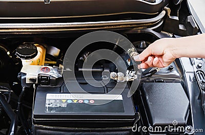 disconnecting battery in car before parking for long time. disconnects car battery terminal Stock Photo