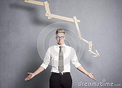 Discontented businessman in front of graph with negative trend. Stock Photo