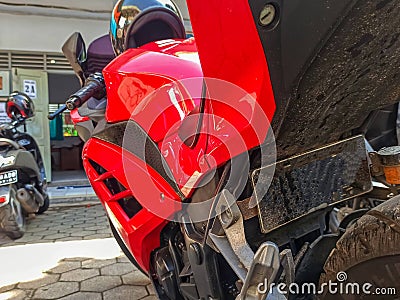 Urban Adventure: Red Kawasaki Ninja Motorcycle at Rest in Sukoharjo's Paved Courtyard Stock Photo