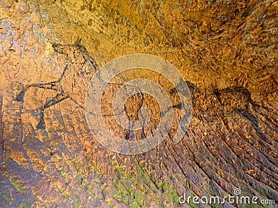 Discovery of prehistoric paint of horse in sandstone cave. Spotlight shines on historical human painting Stock Photo