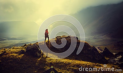 Discovery Travel Destination Concept. Hiker Woman With Backpack Rises To The Mountain Top Against Backdrop Of Sunset Vintage Toned Stock Photo