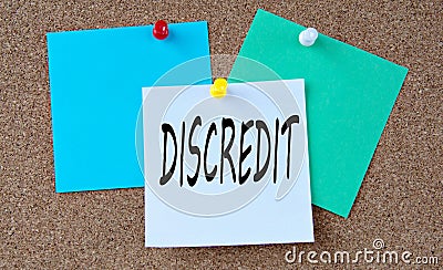 DISCREDIT - word on colorful pieces of paper attached to the note board Stock Photo