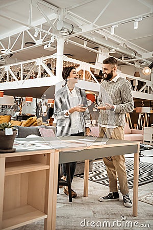 Curious concentrated couple inspecting colorful samples of table surface Stock Photo