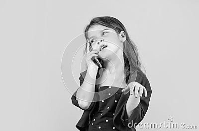 Discussing news. Nice talk. Happy childhood. Small child with smartphone. Cheerful little girl yellow background. Girl Stock Photo