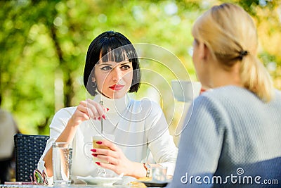 Discussing rumors. Trustful communication. Friendship sisters. Friendship meeting. Closest people. Girls friends drink Stock Photo