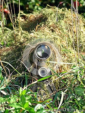 Disguised Sniper and His Rifle Stock Photo