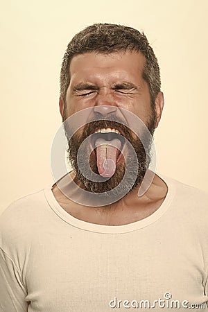 Disgust. man with long beard with closed eyes and tongue Stock Photo