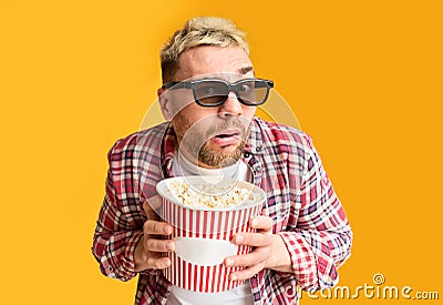 Movie evening. Surprised guy funny holding to bucket Stock Photo