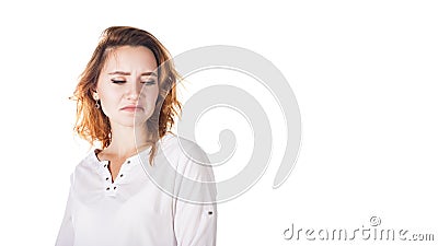 Disgusted and frowning young woman on a white background Stock Photo