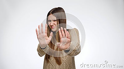 Disgusted girl saw something unpleasant closing eyes and making denying or refusal gesture Stock Photo