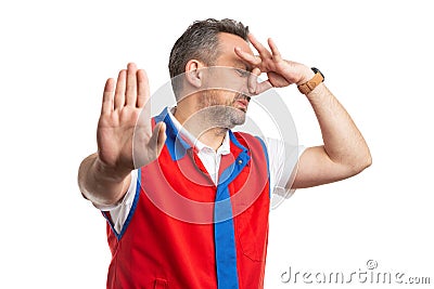 Supermarket employee making gross smell gesture Stock Photo