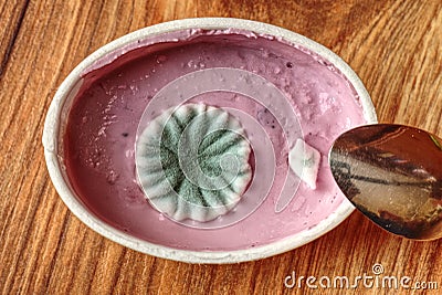 Disgusting mould in cup of strawberry yogurt Stock Photo