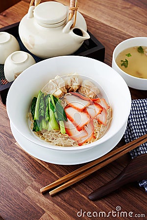 Asian barbecued pork egg noodle with wonton and a soup. Stock Photo