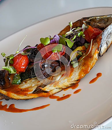 Dish of baked bream with vegetables in a gourmet restaurant Stock Photo