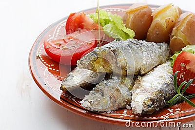 Dish of cooked sardines with salt Stock Photo