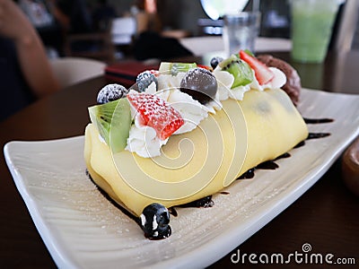 Dish of fresh crape cake with sliced fruits Stock Photo