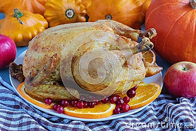 Dish with fried chicken, pumpkin, squash, apples on the kitchen table. Thanksgiving Day Stock Photo