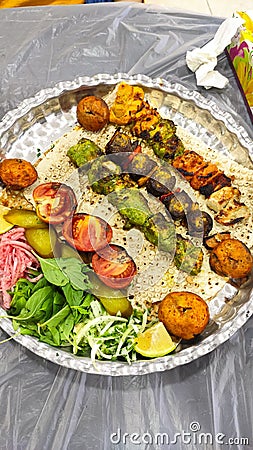 A dish full off Persian Food kebab chicken and joojeh Stock Photo