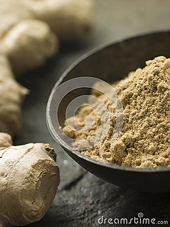 Dish of Ginger Powder with Fresh Ginger Root Stock Photo