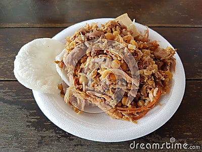 Dish of lechona, a traditional food from espinal, tolima, Colombia over a wood table Stock Photo