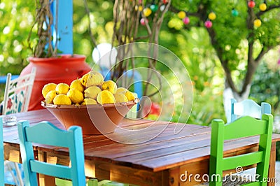 A dish of lemons in typical greek outdoor cafe Stock Photo