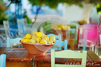 A dish of lemons in typical greek outdoor cafe Stock Photo