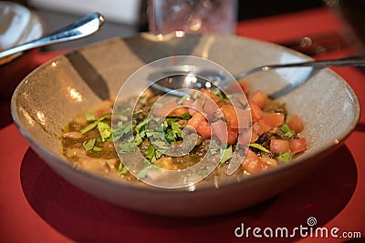 A dish with local peruvian meet in corinander soup with tomato Editorial Stock Photo