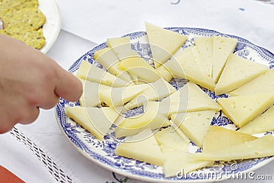 Dish of Manchego Curado cheese pieces cut in triangles Stock Photo