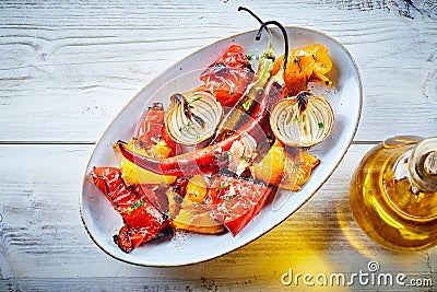 Dish of organic roast vegetables with oil Stock Photo