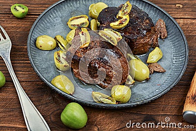 Fried ostrich steak with kiwi sauce Stock Photo