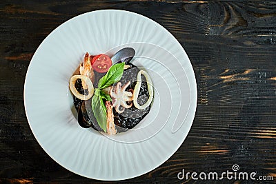 Dish of risotto with squid ink on grey plate jpg Stock Photo