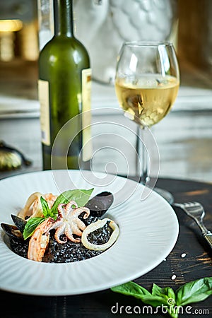 Dish of risotto with squid ink on grey plate jpg Stock Photo