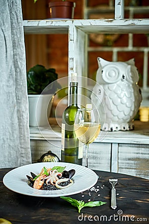 Dish of risotto with squid ink on grey plate jpg Stock Photo